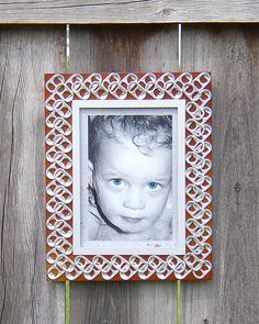 an old photo frame with a baby's blue eye is hanging on a wooden fence