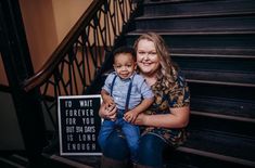 a woman and child sitting on the stairs