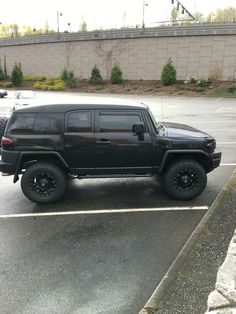 a black jeep parked in a parking lot