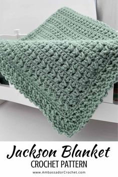 a green crocheted blanket sitting on top of a white shelf