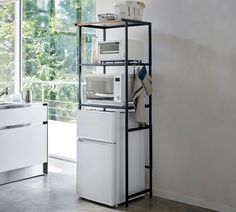 a white refrigerator freezer sitting next to a window