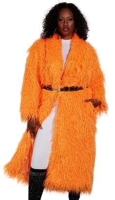 Introducing the Luxe Moda LM230 Church Coat, a garment that effortlessly combines style with comfort. This magnificent coat features a striking orange hue that is sure to turn heads and add a pop of color to any ensemble. Crafted from premium faux fur, the texture is both luxurious and eco-friendly, making it an exquisite choice for fashion-forward individuals. Designed to fall at a flattering mid-length, this coat provides ample coverage while still maintaining a sleek silhouette. Its loose fit ensures a comfortable wearing experience without restricting movement, making it perfect for a variety of occasions from formal church services to festive evening events. The open front and soft inner lining enhance the coat's cozy feel, while side pockets add a practical touch, allowing you to kee Long Orange Outerwear For Fall, Orange Long Sleeve Outerwear For Spring, Oversized Orange Outerwear For Spring, Spring Oversized Orange Outerwear, Fitted Orange Long Sleeve Outerwear, Long Orange Outerwear For Spring, Oversized Orange Outerwear For Work, Long Orange Spring Outerwear, Chic Fitted Orange Outerwear