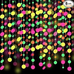 the colorful lights are hanging down from the black background, and there is no image to describe