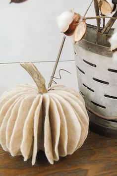 a white pumpkin sitting on top of a wooden table