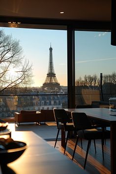 a room with a view of the eiffel tower in paris, france at sunset