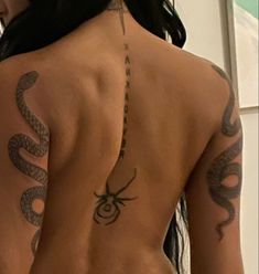 the back of a woman with tattoos on her body