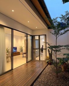 an outdoor living area with wood flooring and sliding glass doors