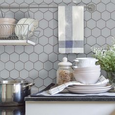 the kitchen counter is set with dishes and utensils