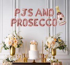 there is a cake on the table with balloons and flowers in front of it that says pj's and proseco