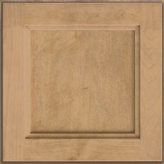 a close up view of a wooden cabinet door with an unfinished square in the center