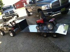 a truck is pulling a trailer with two atvs attached to it and another vehicle in the background