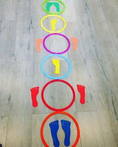 an image of a person standing in front of a line of colorful hoop tossers