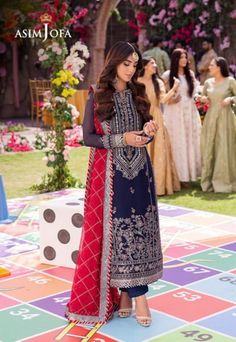 By Pcs: 3 Pcs Shirt: Chiffon Trouser: Lawn Silk Dupatta: Chiffon Color: Blue Step into the limelight with "Jag Mag Collection" by Asim Jofa. This navy-blue masterpiece is a testament to the grandeur of celebrations adorned with a majestic floral border that blooms in the hues of reddish-pink, gray, and dull mauve threadwork. The light gold sequins and zari embroidery weave a narrative of opulence while the reddish-pink dupatta embroidered on both sides adds a vibrant dimension to this luxurious Wedding Dress Indian, Salwar Kameez Wedding, Punjabi Suits Party Wear, Dress Pakistani, Wedding Dresses Indian, Asim Jofa, Party Wear Dress, Pakistani Salwar, Salwar Dress