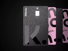 three credit cards with different designs on them, one is pink and the other is black