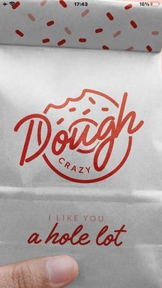 a person holding up a bag with donut crazy written on it and the words i like you a hole lot