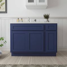 a bathroom with blue cabinets and white walls