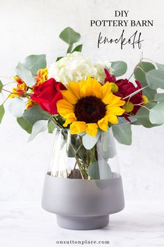 a vase filled with flowers sitting on top of a white countertop next to green leaves