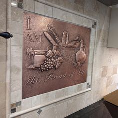 there is a plaque that says it am the bread of life on the wall in this kitchen