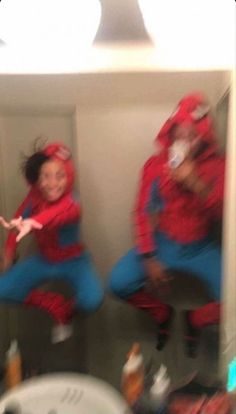 two people dressed in red and blue jumping into the air