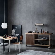 a dining room with a table and chairs next to a large painting on the wall