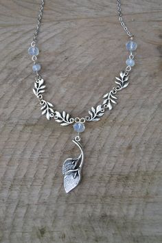 PLEASE read my shop announcement before placing an order so you know what to expect right now. Plus, when ordering from outside Europe, don't forget to provide a phone number for the courier to ensure the fastest and smoothest delivery. Lily calla and leaves branches necklace in silver tone beaded with dainty faceted opalite beads. Romantic and stunning. This is a short necklace, almost choker, about 40 cm, 15.7 inches, fastens with lobster clasp and has a 6 cm, 2.3 inches, extension chain. Tibe Nature-inspired Wire Wrapped Sterling Silver Necklaces, Nature-inspired Sterling Silver Wire Wrapped Necklaces, Whimsical Silver Pendant Jewelry, Bohemian Silver Czech Glass Necklaces, Bohemian Silver Czech Glass Jewelry, Bohemian Silver Necklace With Czech Glass, Bohemian Czech Glass Silver Jewelry, Silver Wire Wrapped Nature-inspired Jewelry, Silver Nature-inspired Wire Wrapped Jewelry