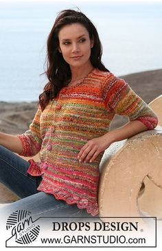 a beautiful woman sitting on top of a wooden bench next to the ocean with her hands on her hips