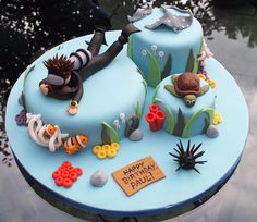 a birthday cake decorated with sea life on a table