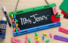 a blackboard with the words mrs jones surrounded by school supplies