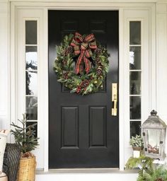 a christmas wreath on the front door of a house