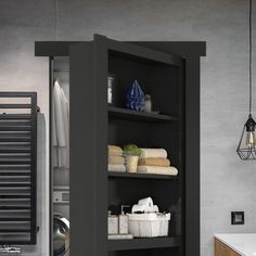 an open cabinet in a bathroom with towels and other items on the shelf next to it