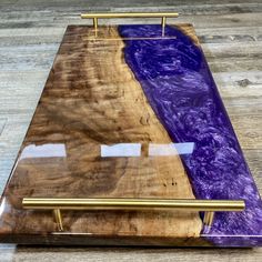 a wooden table with purple and gold paint on it