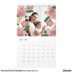 a calendar with an image of a woman holding a baby in her lap and flowers on it