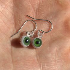 Treat yourself to something fun and spooky today! These eyes are so tiny you have to see them in person to believe the miniscule details. I think it would also be a great gift for any gothic friends you have :) Different materials are available for the ear wire (the hook that goes through the ear), select yours from the drop down menu. Pictured hooks are sterling silver. Quirky Handmade Halloween Jewelry, Handmade Sterling Silver Halloween Earrings, Green Earrings For Halloween Gift, Novelty White Round Earrings, Green Halloween Dangle Earrings, Green Novelty Earrings For Halloween, Green Novelty Jewelry For Halloween, Handmade Green Halloween Earrings, Eyeball Jewelry