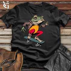 Introducing our Frog Skates Cotton Tee, made from 100% cotton from the reputable Bella Canvas. Enjoy the luxurious feel of this irresistibly soft t-shirt, featuring a beautiful design of lily pad hopping frogs. The perfect item to add to any wardrobe. Show off your unique style and love for the outdoors with this charming piece. #funsummerstyle Cool Frog, Jocko Willink, Thrift Inspo, Boots Jeans, Skate Park, The Frog, Fan Club, Frogs, Modern Fit