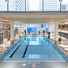 an indoor swimming pool surrounded by tall buildings