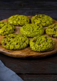 green cookies with chocolate chips on a wooden platter