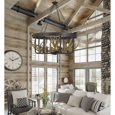 a living room filled with furniture and a large clock hanging from the ceiling above it