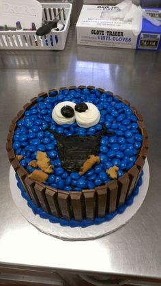 a cake decorated with chocolate and blue candies in the shape of a cookie monster