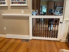 a dog standing behind a gate in a living room