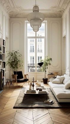 a living room filled with lots of furniture and a large window in the center of it