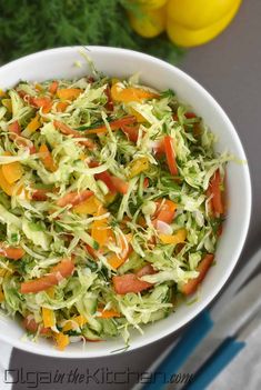 a white bowl filled with coleslaw and carrots on top of a table