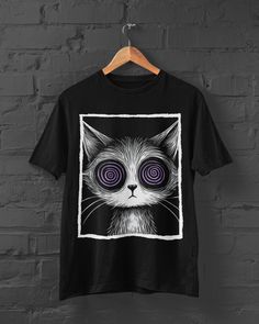 Step into the allure of darkness with our Hypnotic Cat T-shirt. This gothic clothing piece captures the essence of dark aesthetic fashion with its enchanting feline design and hypnotic eyes, perfect for those who appreciate the mysterious allure of dark art and the captivating gaze of a scary cat.   👉Unisex T-shirt👈 - 100% ring-spun cotton. - The double-needle stitching throughout the tee makes it highly durable while the lack of side-seams helps the shirt retain its tubular shape. - The pre-s Black Cat Print T-shirt For Streetwear, Spooky Black T-shirt With Cat Print, Black Alternative T-shirt With Anime Print, Black Alternative Anime Print T-shirt, Black Alternative Style T-shirt With Anime Print, Black Halloween T-shirt With Cat Design, Halloween Black T-shirt With Cat Design, Spooky Black T-shirt With Cat Design, Hypnotic Eyes