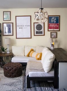 a living room filled with lots of furniture and pictures on the wall above it's coffee table