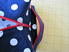 the zipper is open to show what's in the fabric and it looks like polka dots