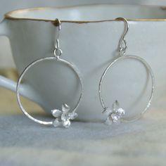 These elegant sterling silver hoop earrings feature dainty daffodil flowers and are the ideal gift to celebrate a treasured occasion. Originally hand-carved, the daffodil hoop earrings are lovingly handmade with intricate attention to detail. They are also super easy and secure to wear even without a fiddly catch. All our jewellery is beautifully packaged in high quality black velvet boxes to perfectly show off your unique handmade gift. Matching daffodil necklace and stud earrings can be found Daffodil Flowers, Daffodil Flower, Sterling Silver Hoop Earrings, Sterling Silver Hoops, Jewelry Earrings Hoops, Silver Hoops, Silver Hoop Earrings, Daffodils, Gold Plated Sterling Silver