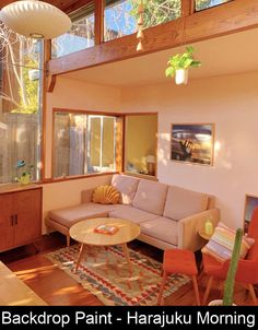 a living room filled with furniture and lots of windows