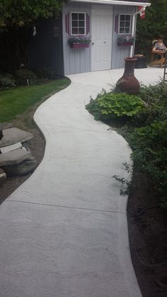 a walkway leading to a small white house