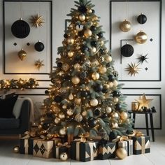 a decorated christmas tree in a living room with black and gold ornaments on the wall