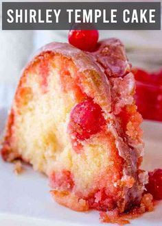 a close up of a piece of cake on a plate with cherries around it