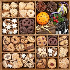 an open wooden box filled with cookies and pastries